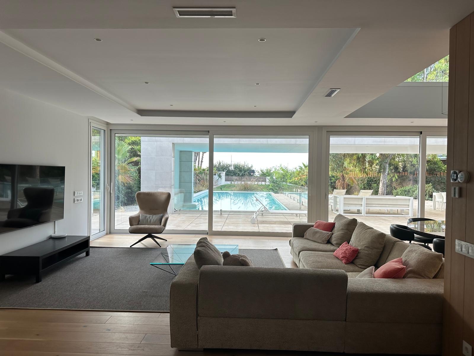 Living room opening onto the pool and beachfront grounds